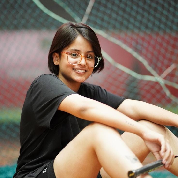 Kaveri Mehta, Lead Design Curator at RippleCurrentWay, reviewing corporate floral arrangements